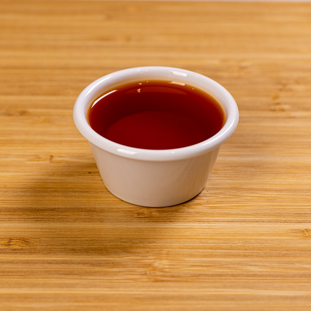 A cup of tea on a wooden table.