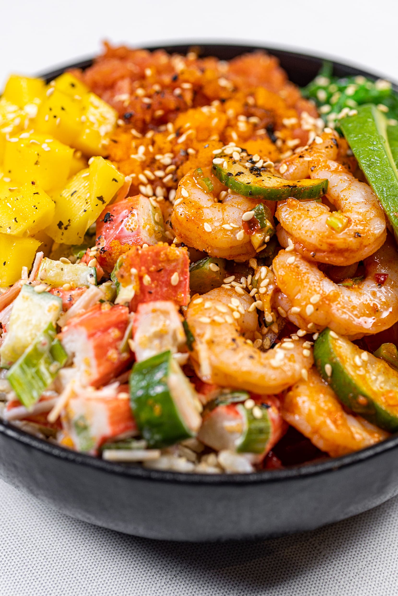 A bowl filled with shrimp and vegetables.