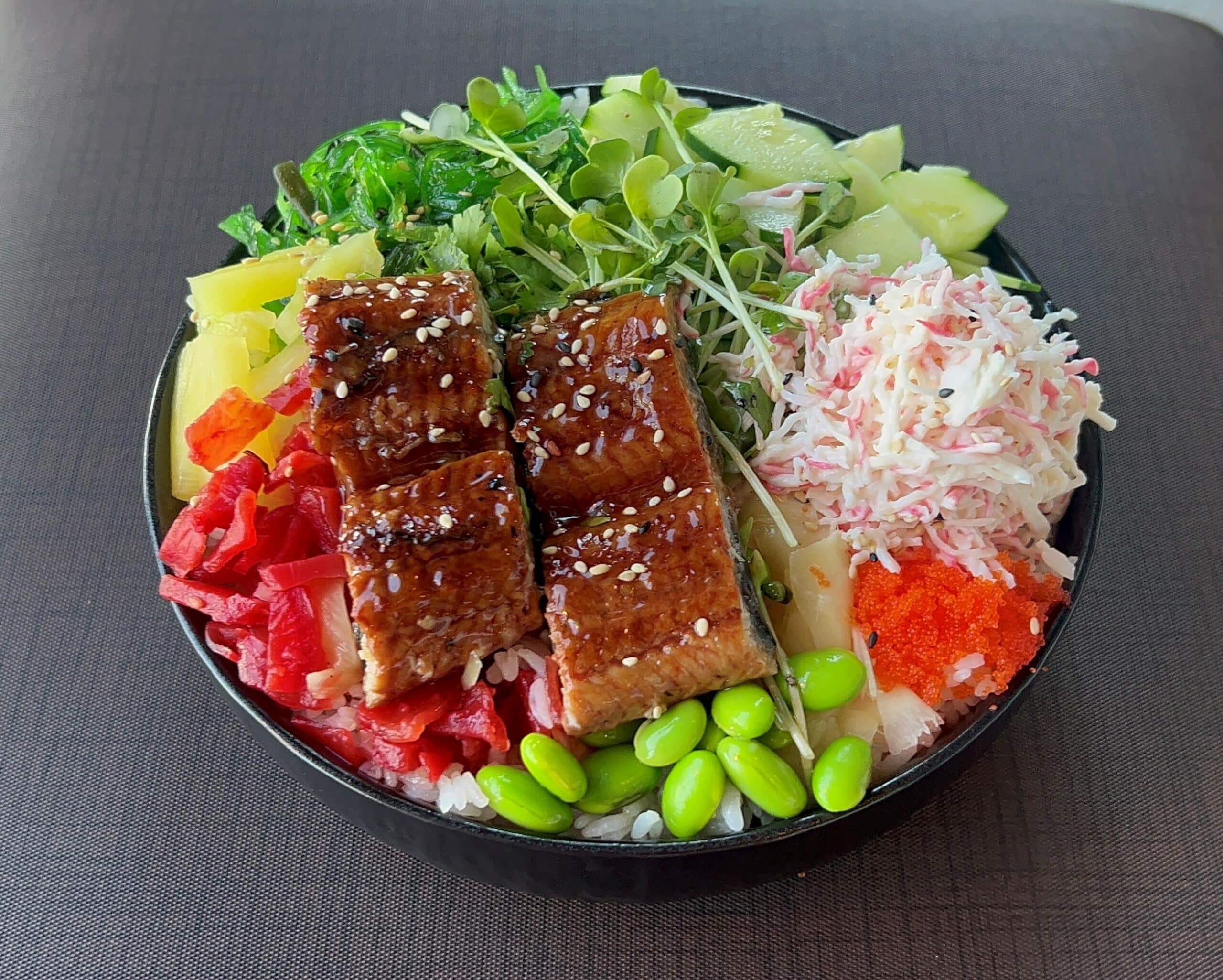 A bowl with a variety of vegetables and meat in it.